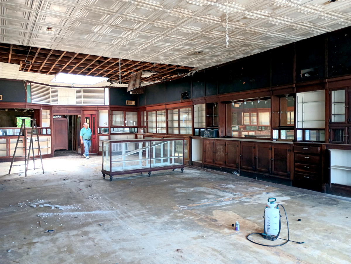Commercial ceiling with a missing section of decorative panels exposing the joists in a retail space in Arp, TX